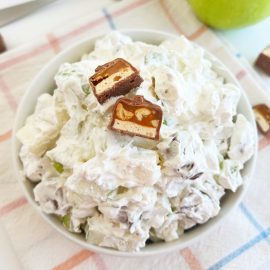 Snickers apple salad with chopped snicker bars in a bowl