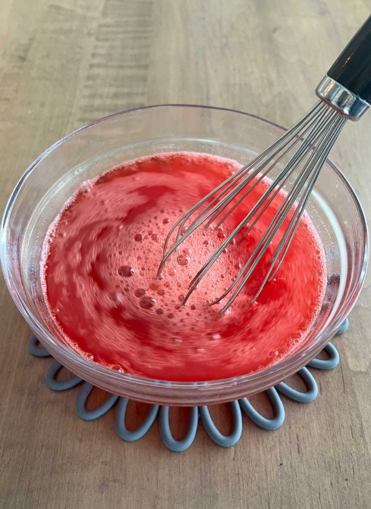 mix strawberry jell-o gelatin with water