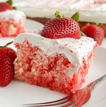 strawberry jello poke cake with cool whip and fresh strawberries