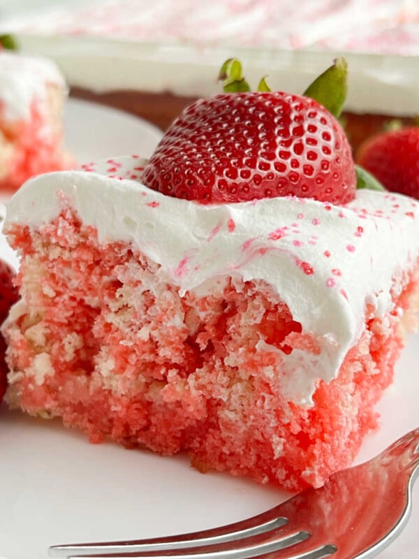 strawberry jello poke cake with cool whip and fresh strawberries