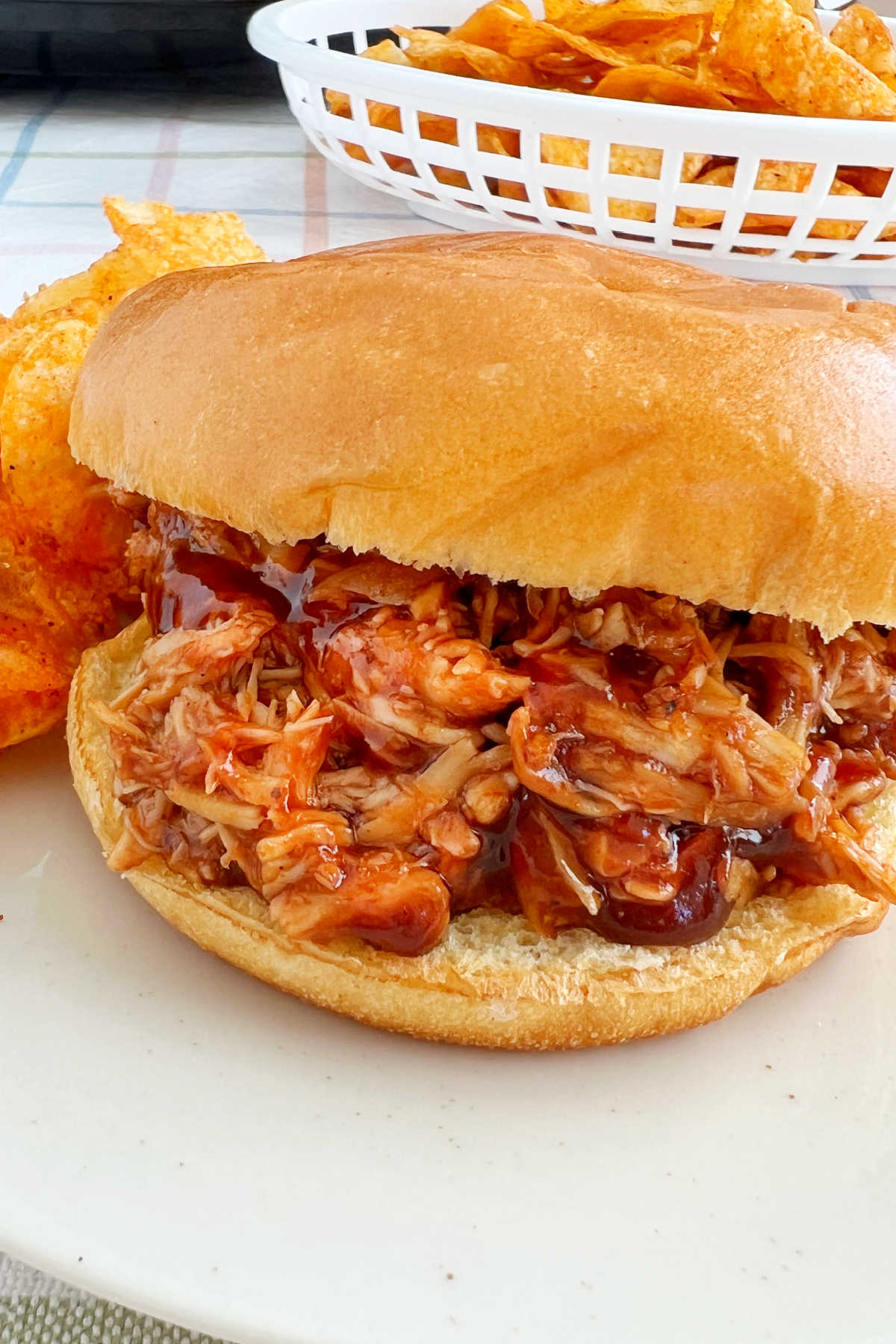 crock pot bbq chicken sandwich on plate with potato chips