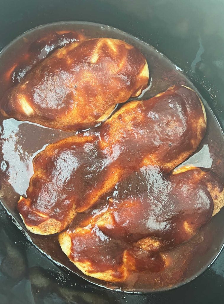 chicken smothered in bbq sauce in slow cooker