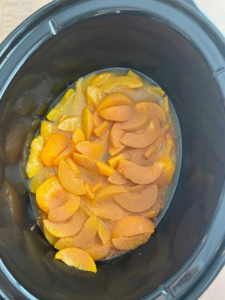 canned peaches with cinnamon in bottom of crock pot