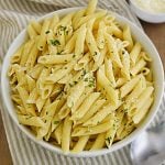 bowl of penne pasta with parsley and Parmesan cheese cooked in the Instant Pot.