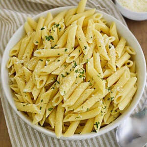 bowl of penne pasta with parsley and Parmesan cheese cooked in the Instant Pot.