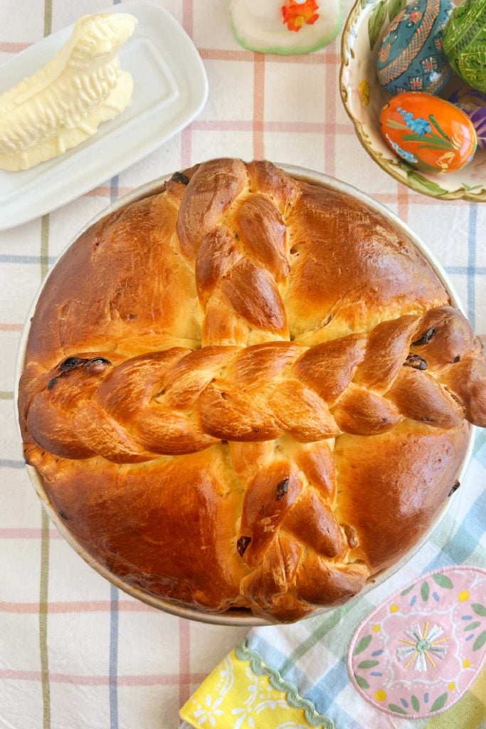 Slovak Paska Easter bread with raisins on table with butter lamb and Ukrainian Easter eggs