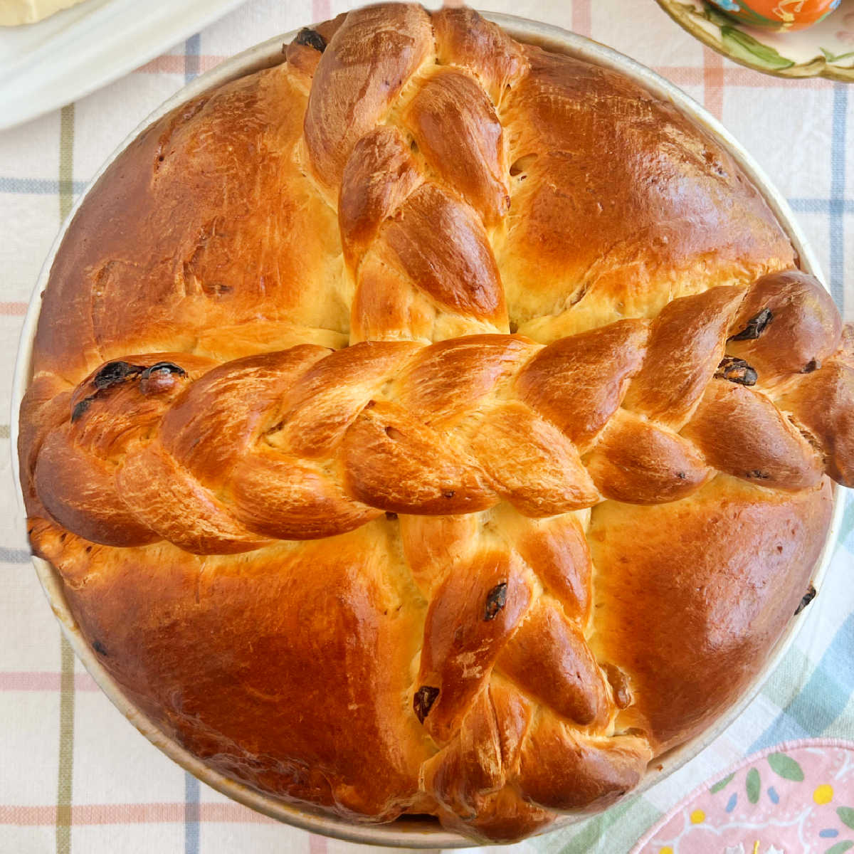 Slovak Easter Paska bread with golden raisins and braided cross in on table