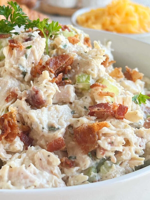 close up of ranch chicken salad with bacon and cheddar cheese in a large bowl