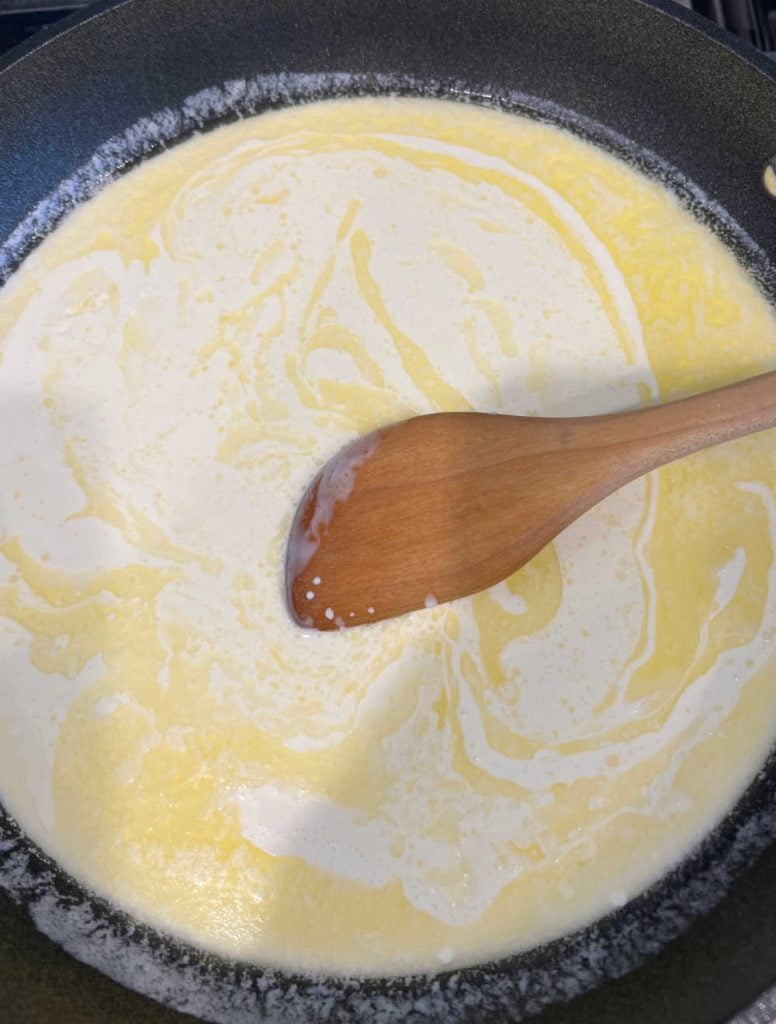 heat butter and heavy cream in skillet and stir with wooden spoon