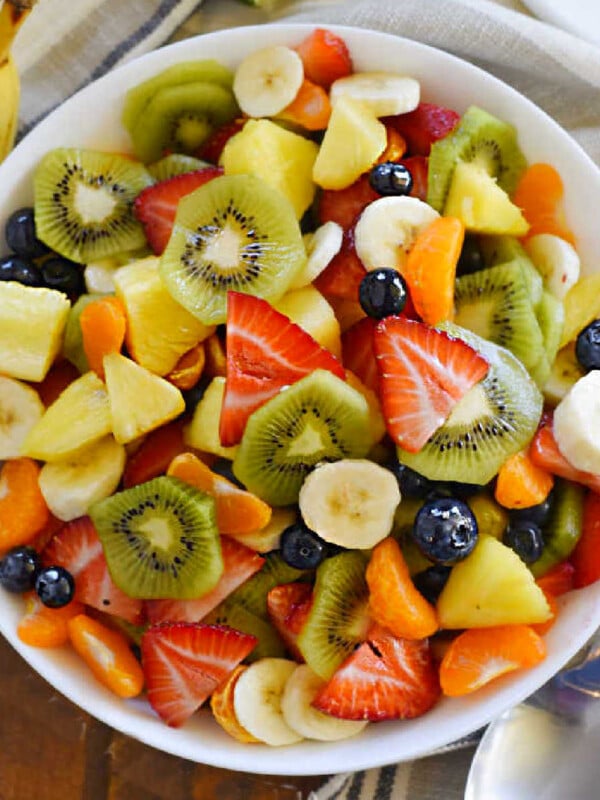 bowl of tropical fruit salad with mandarin oranges, bananas and fresh pineapple