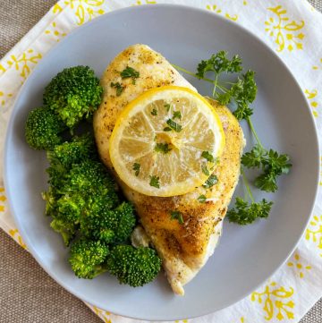 baked lemon pepper chicken breast with broccoli on a plate