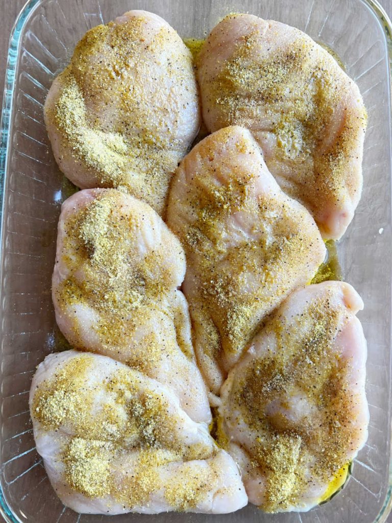 seasoned chicken breasts in a baking dish