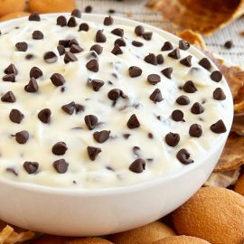 easy cannoli dip with cream cheese and mini chocolate chips in white bowl