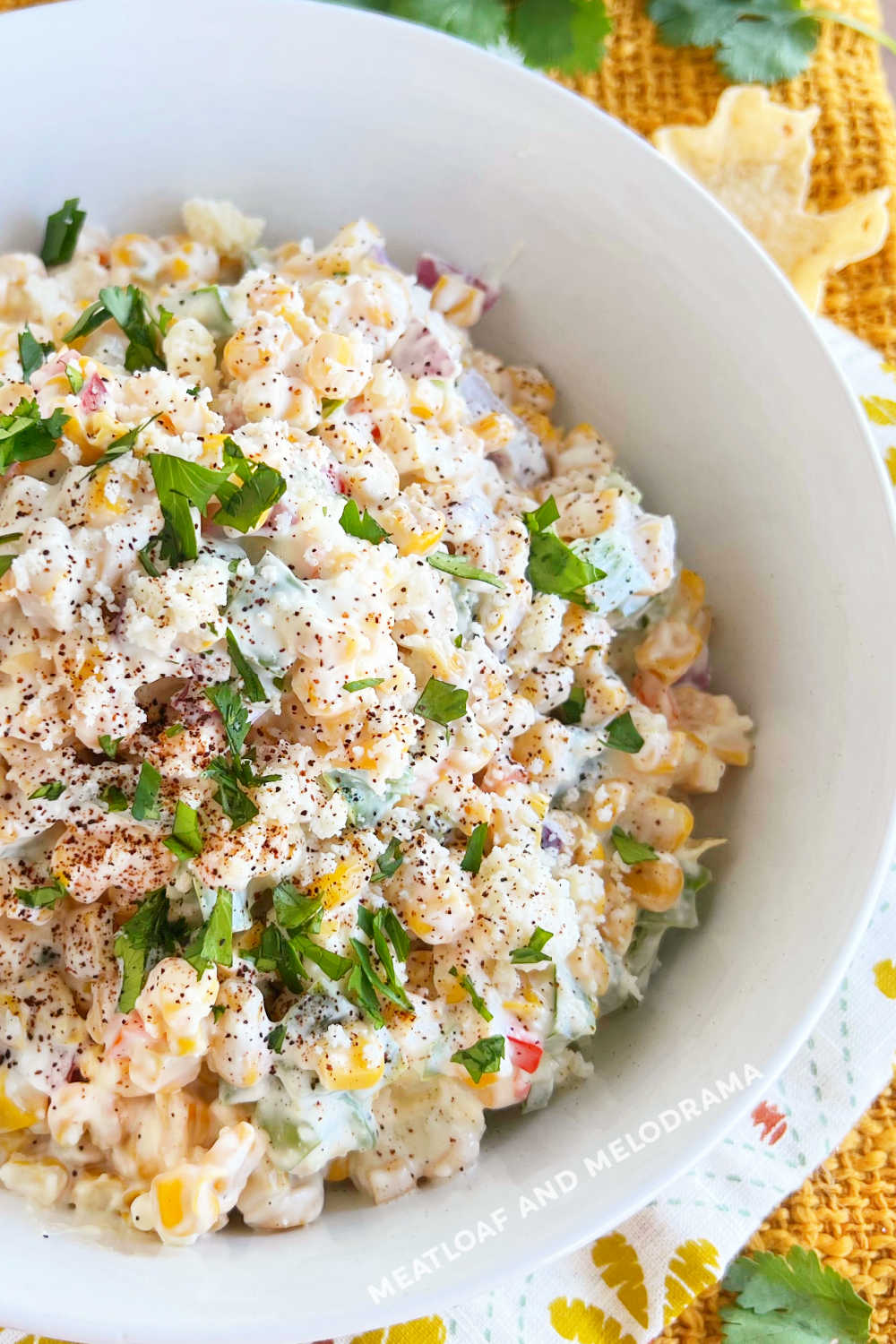 closeup of Mexican corn salad with cilantro in serving bowl