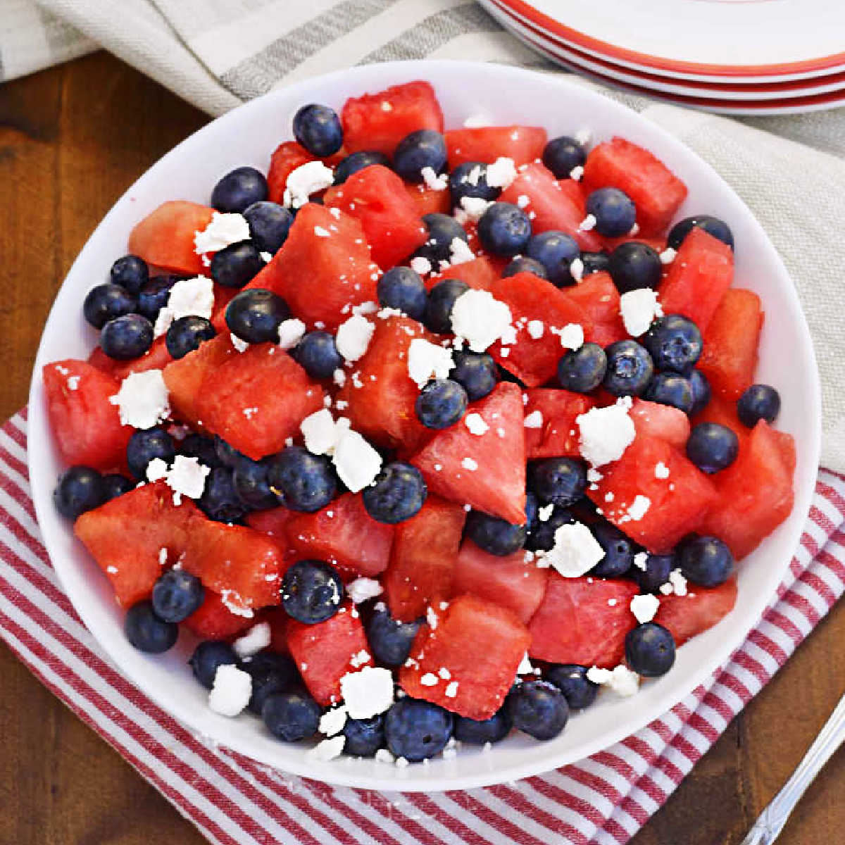 watermelon feta blueberry salad in a white bowl on the table.