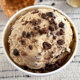 bowl of no-churn coffee ice cream with chocolate covered espresso beans on top.