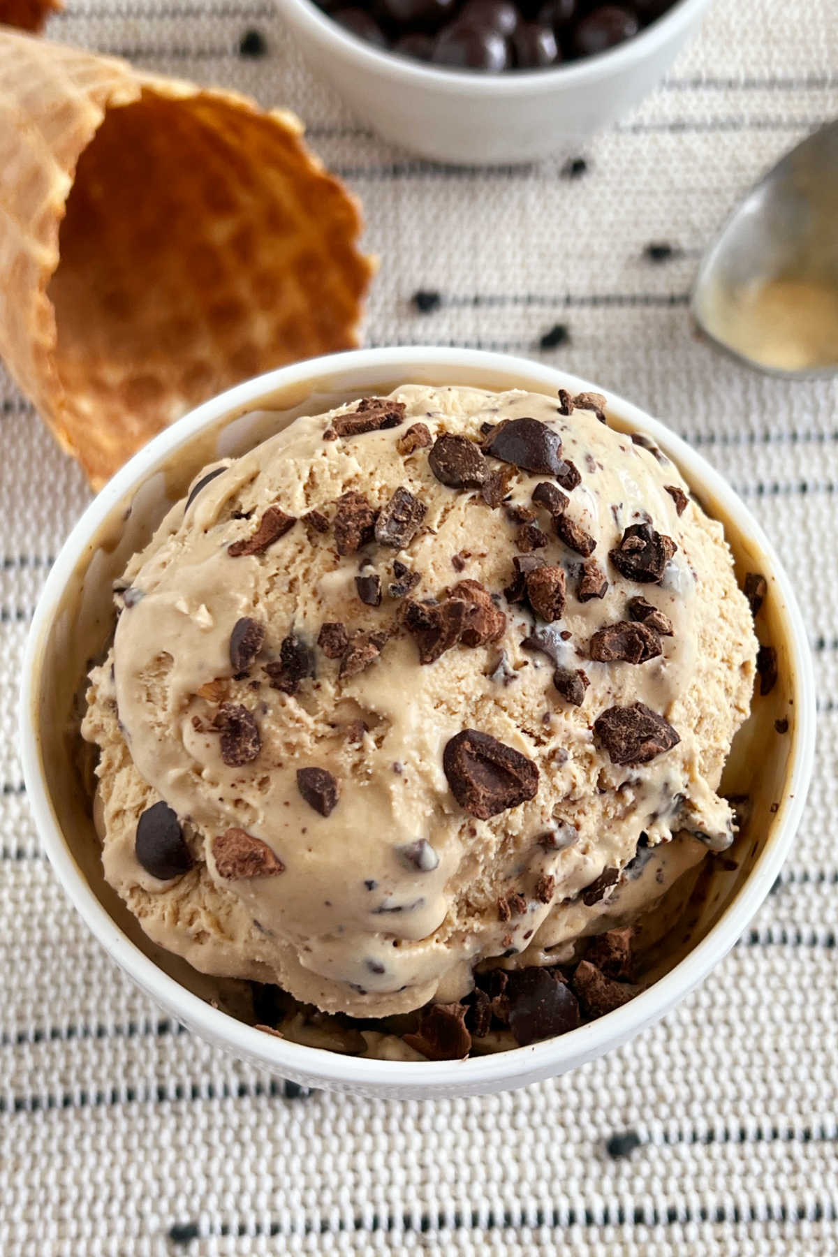 bowl of no-churn coffee ice cream topped with chocolate covered espresso beans.