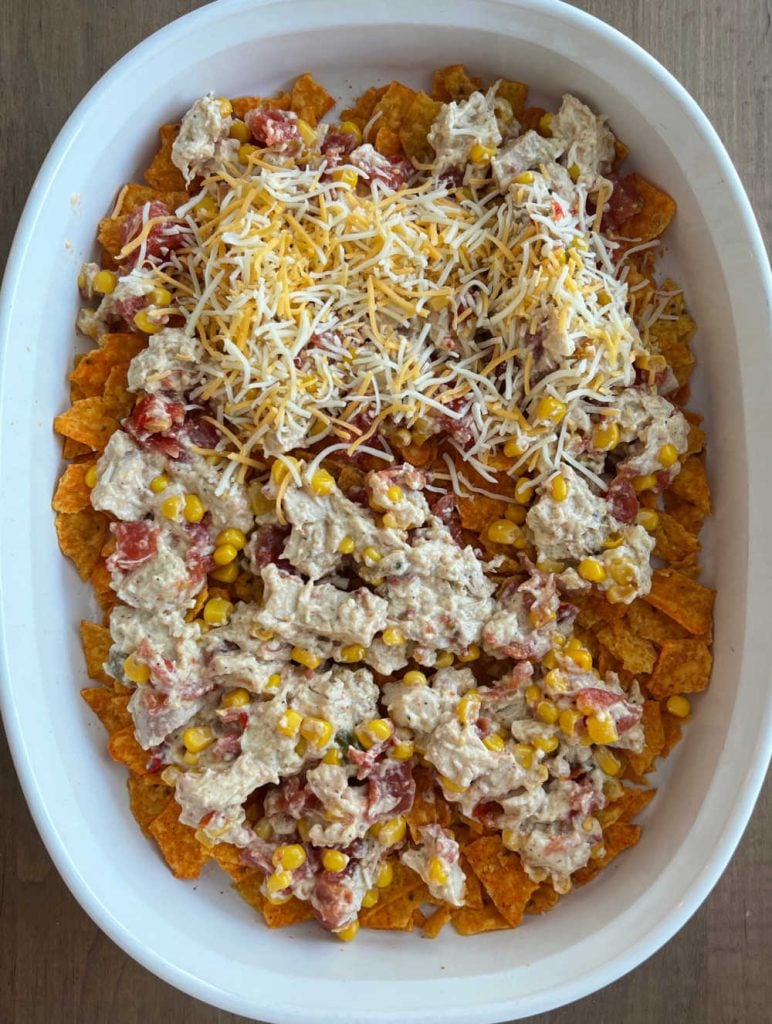 layer chicken mixture and cheese over Doritos in baking dish
