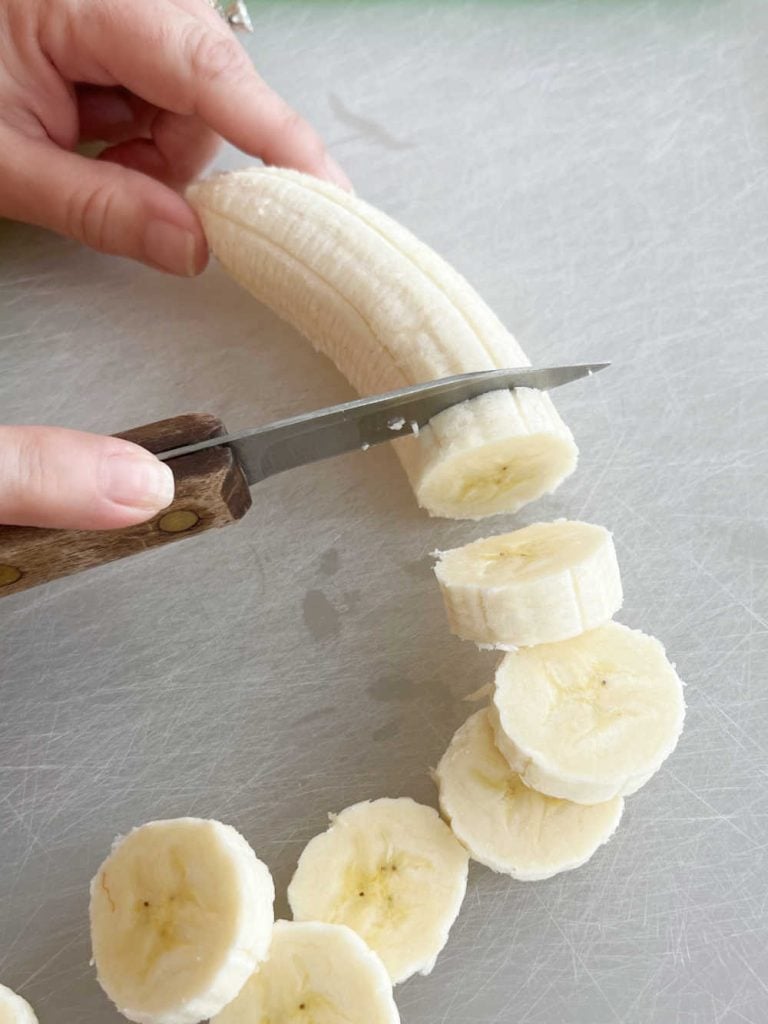 cut ripe banana into slices with knife