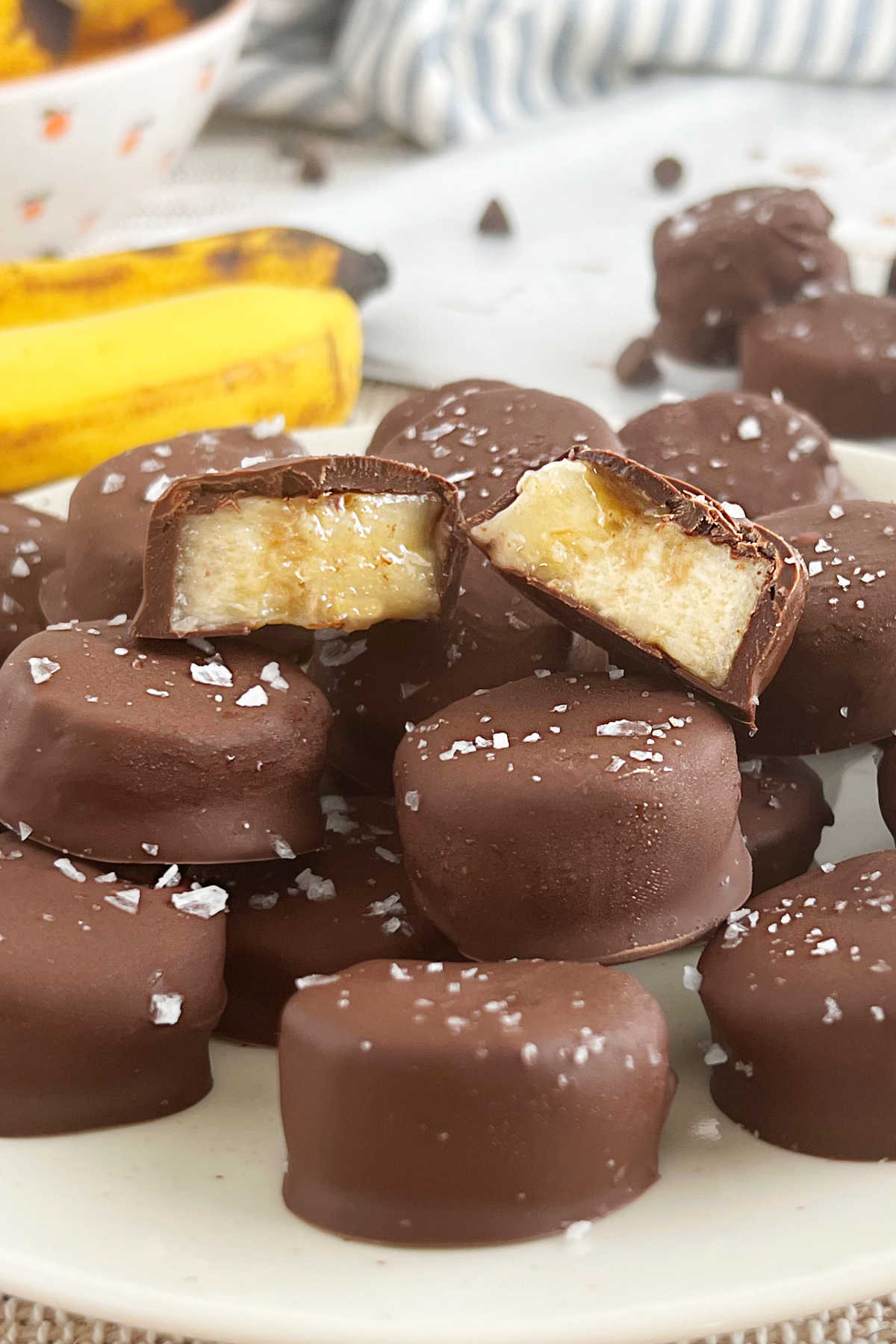 frozen chocolate banana bites cut open and stacked on plate