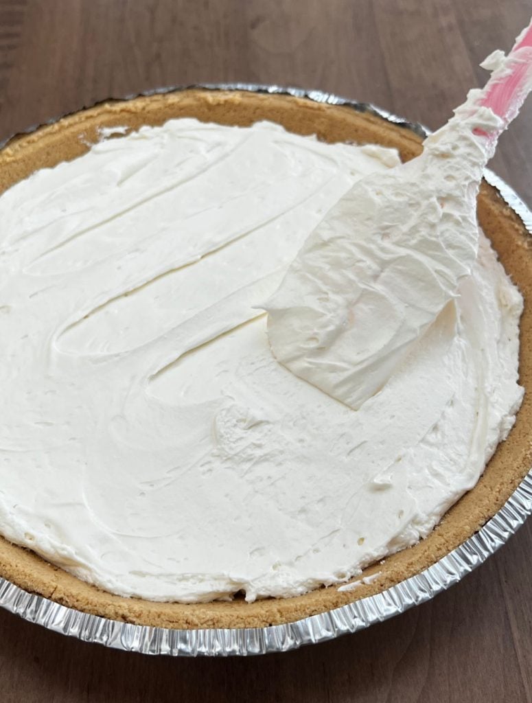 smooth cheesecake filling in graham cracker pie crust