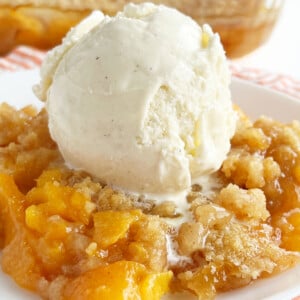 fresh peach crisp without oats topped with scoop of ice cream