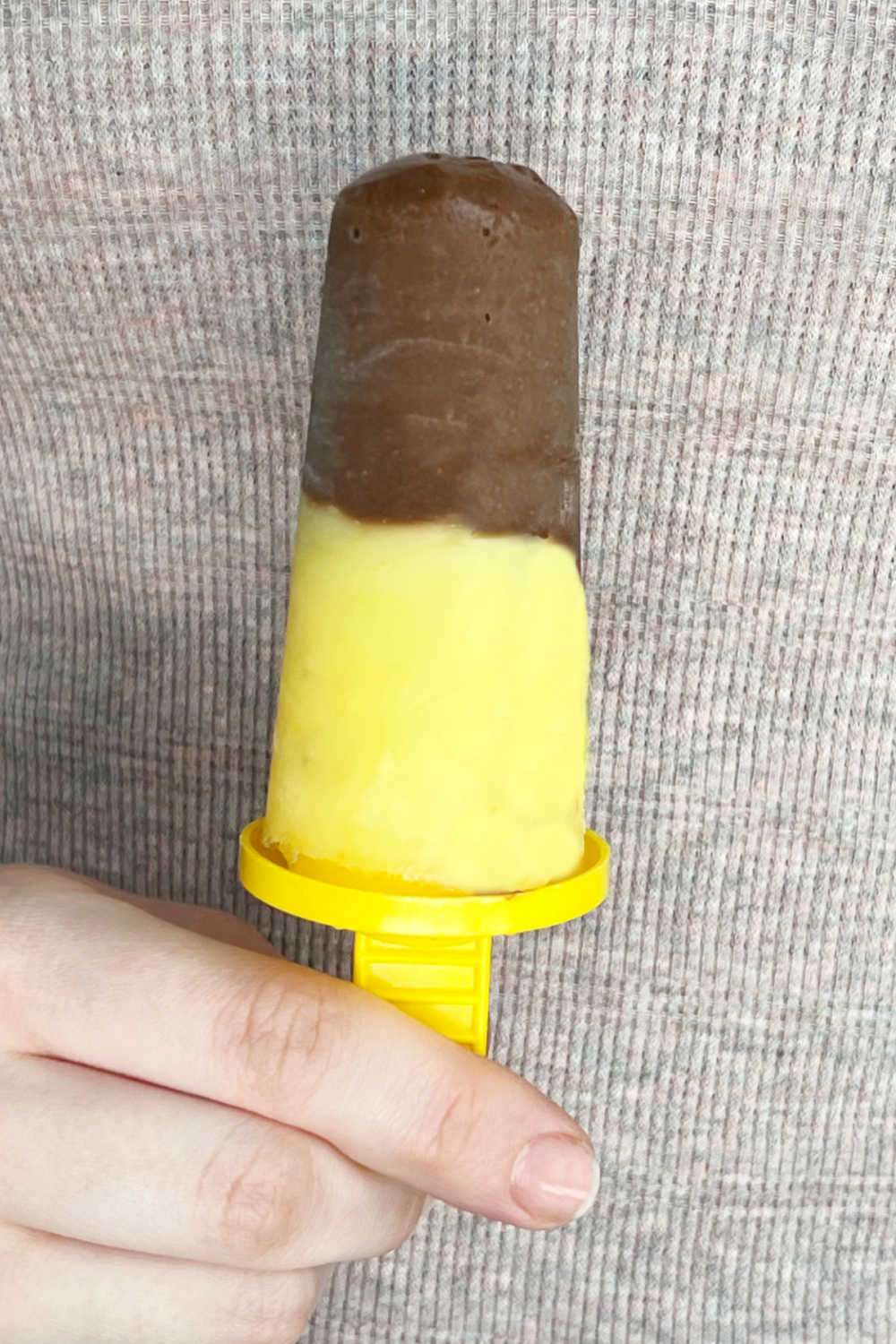 hand holding frozen Jello pudding pop