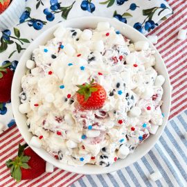 red white and blue cheesecake salad with marshmallows and strawberry on top