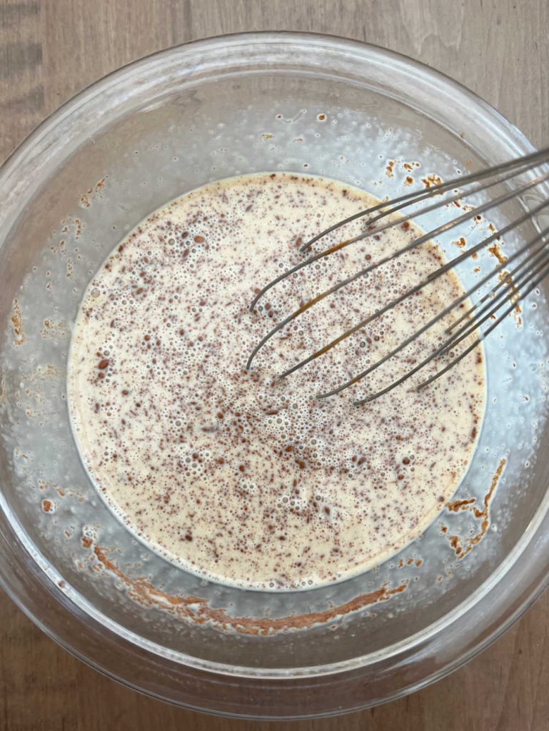 whisk eggs with cream and cinnamon in mixing bowl