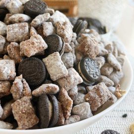 Oreo puppy chow (Muddy Buddies) with Oreo cookies in a serving bowl.