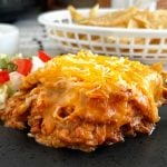 slow cooker chicken enchilada casserole with cheese on plate