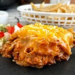 slow cooker chicken enchilada casserole with cheese on plate