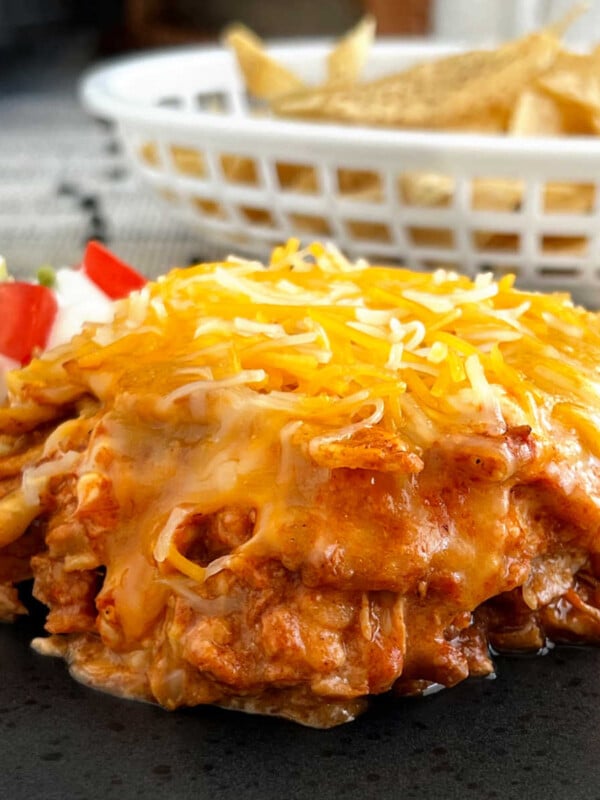 slow cooker chicken enchilada casserole with cheese on plate