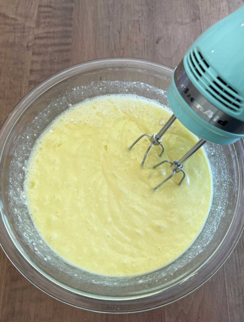 mix cake mix and sprite in mixing bowl with electric mixer