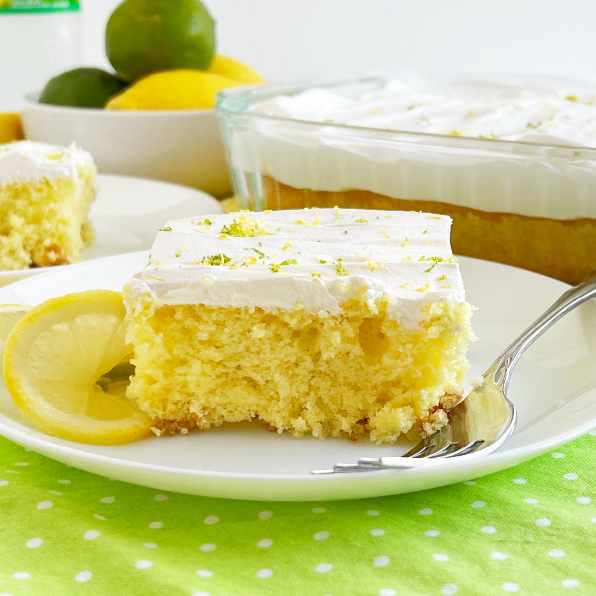 Slice of Sprite cake (lemon lime soda cake) with Cool Whip frosting on a plate