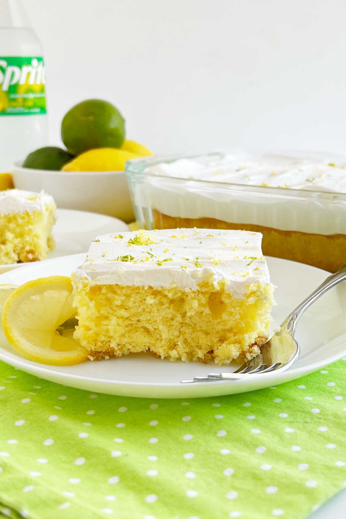 slice of Sprite cake with cool whip frosting on a plate