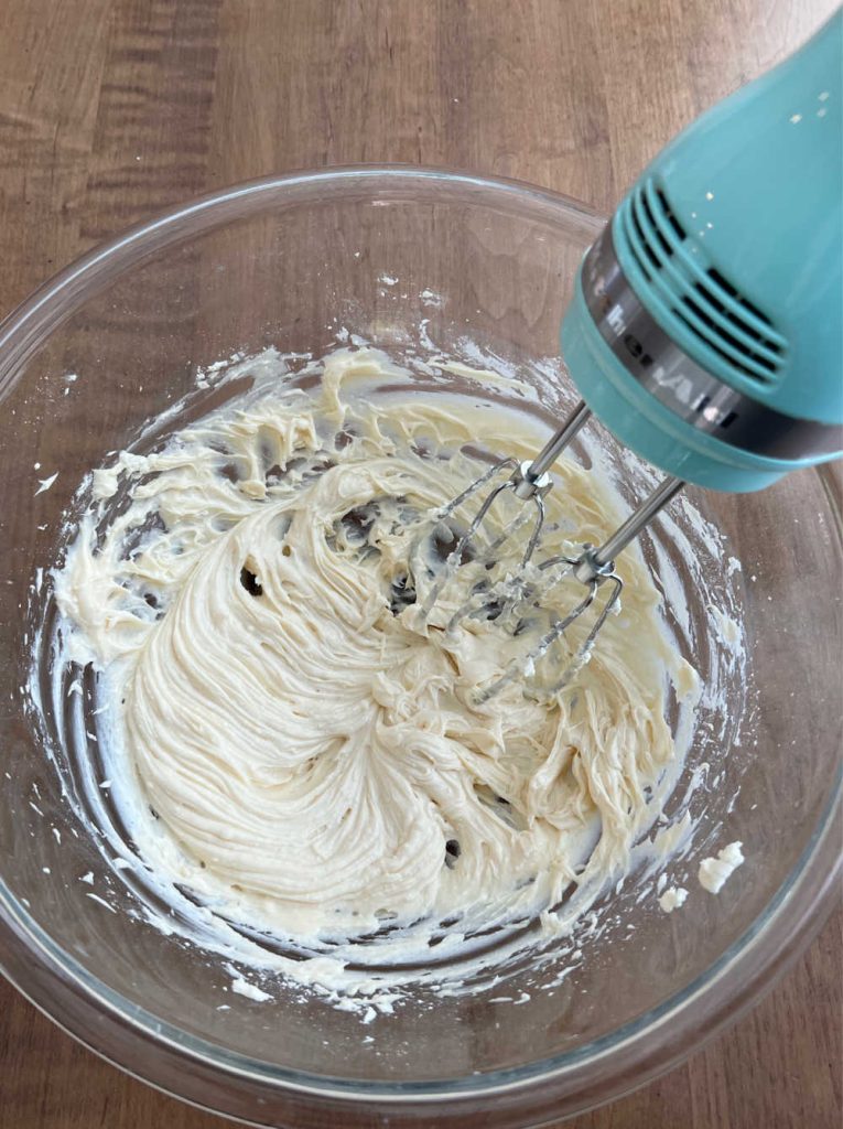mix cream cheese with powdered sugar and vanilla in large bowl with electric mixer