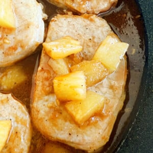 Hawaiian pork chops with pineapple and bbq sauce in skillet.