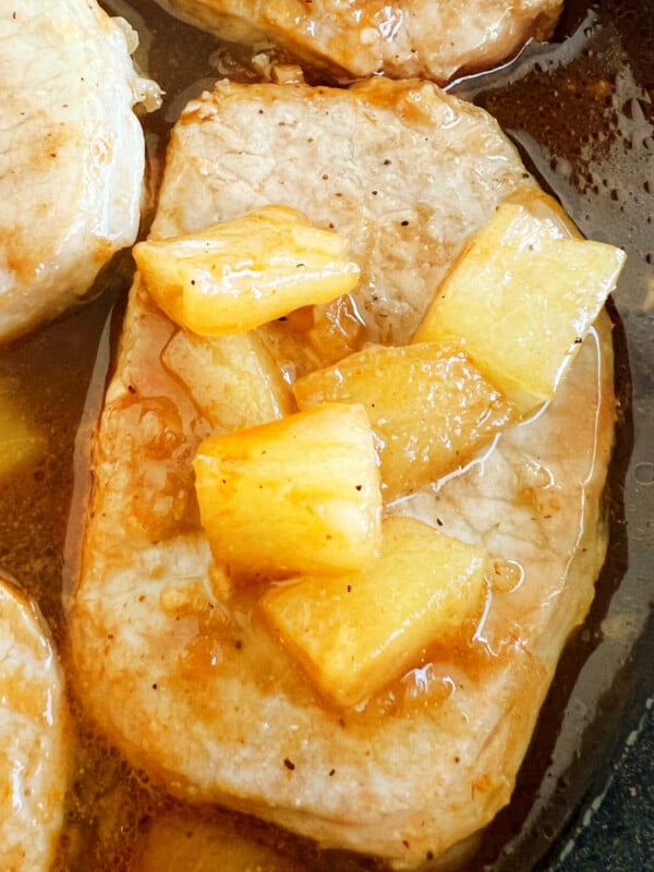 Hawaiian pork chops with pineapple and bbq sauce in skillet.