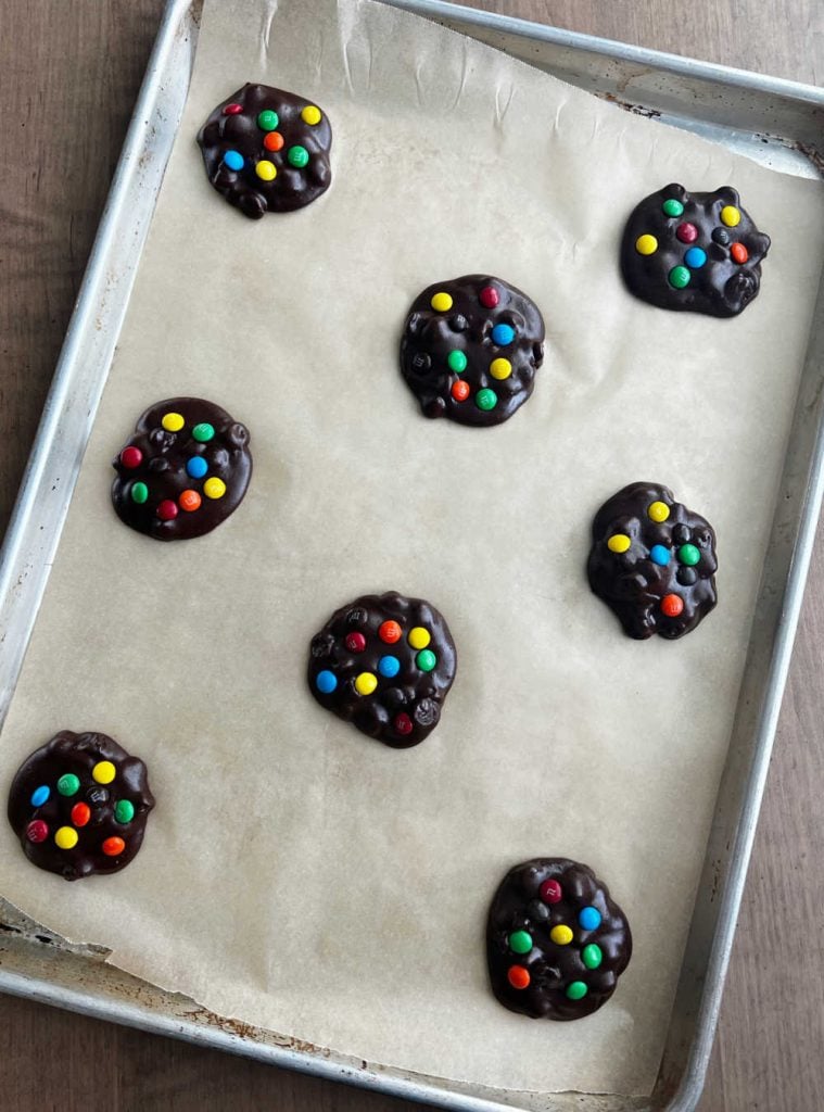 brownie batter cookies on baking sheet with mini m & m's.
