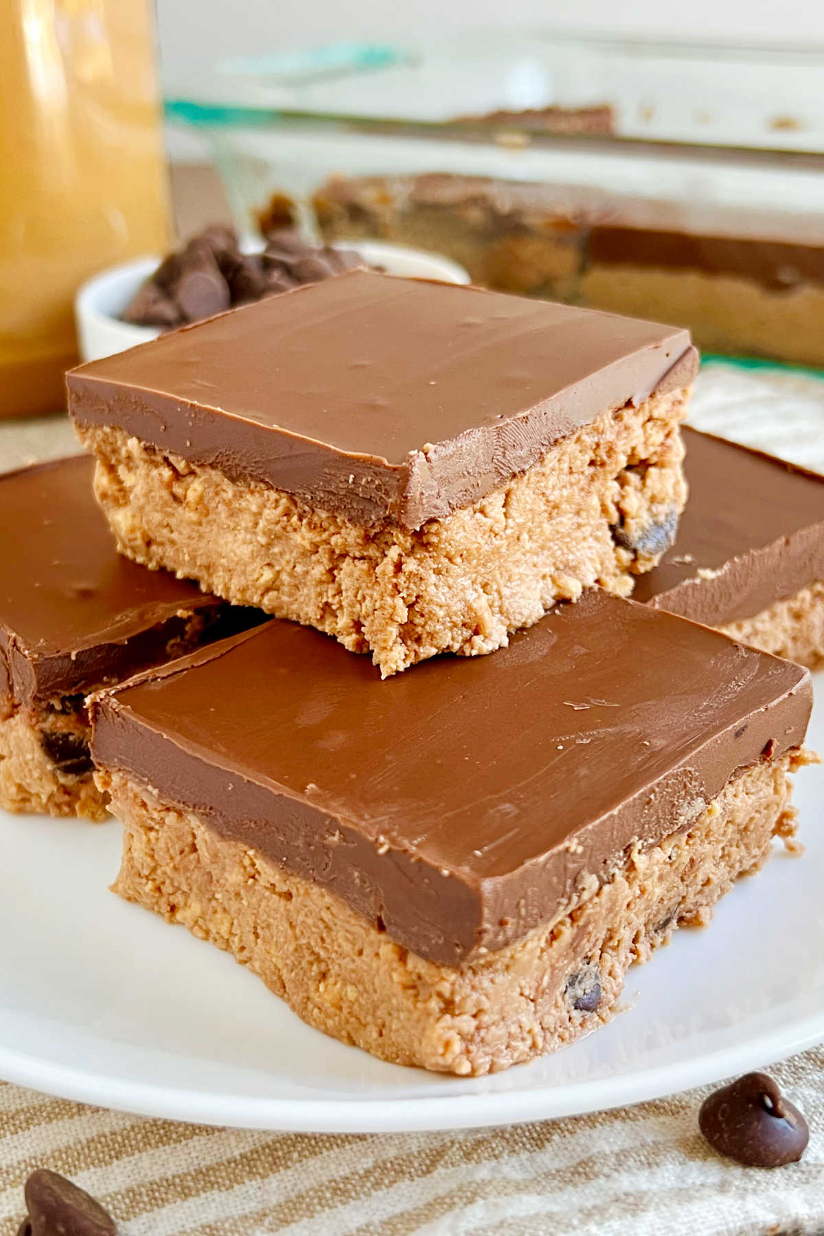 no bake chocolate peanut butter bars with chocolate chips on plate.