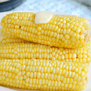 instant pot corn on the cob with butter on white platter.