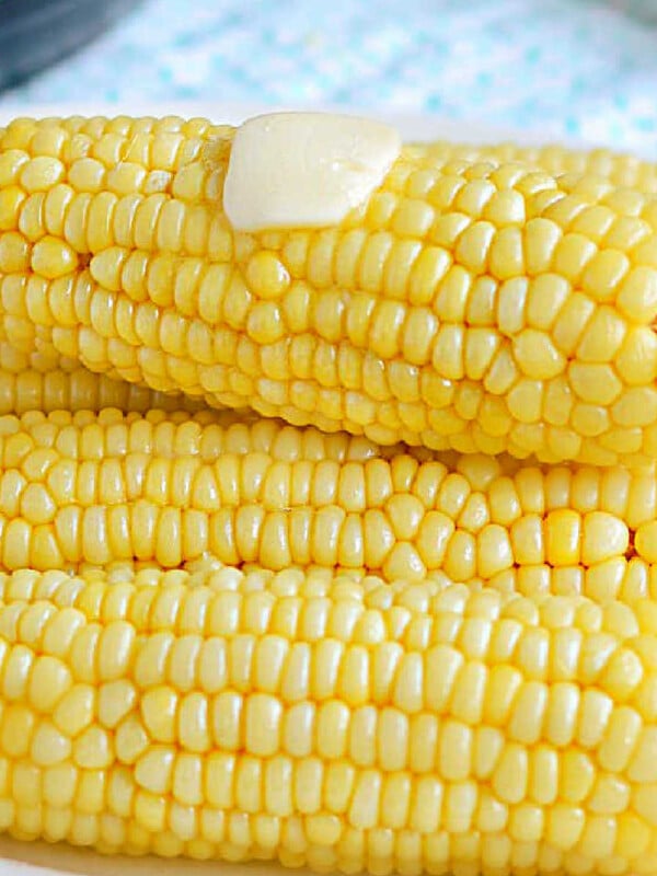 instant pot corn on the cob with butter on white platter.