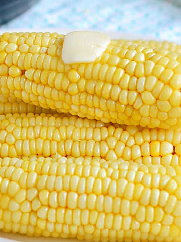 instant pot corn on the cob with butter on white platter.
