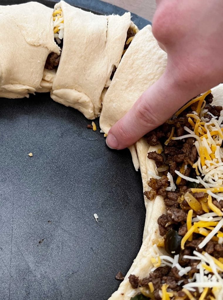fold dough over taco meat with finger.