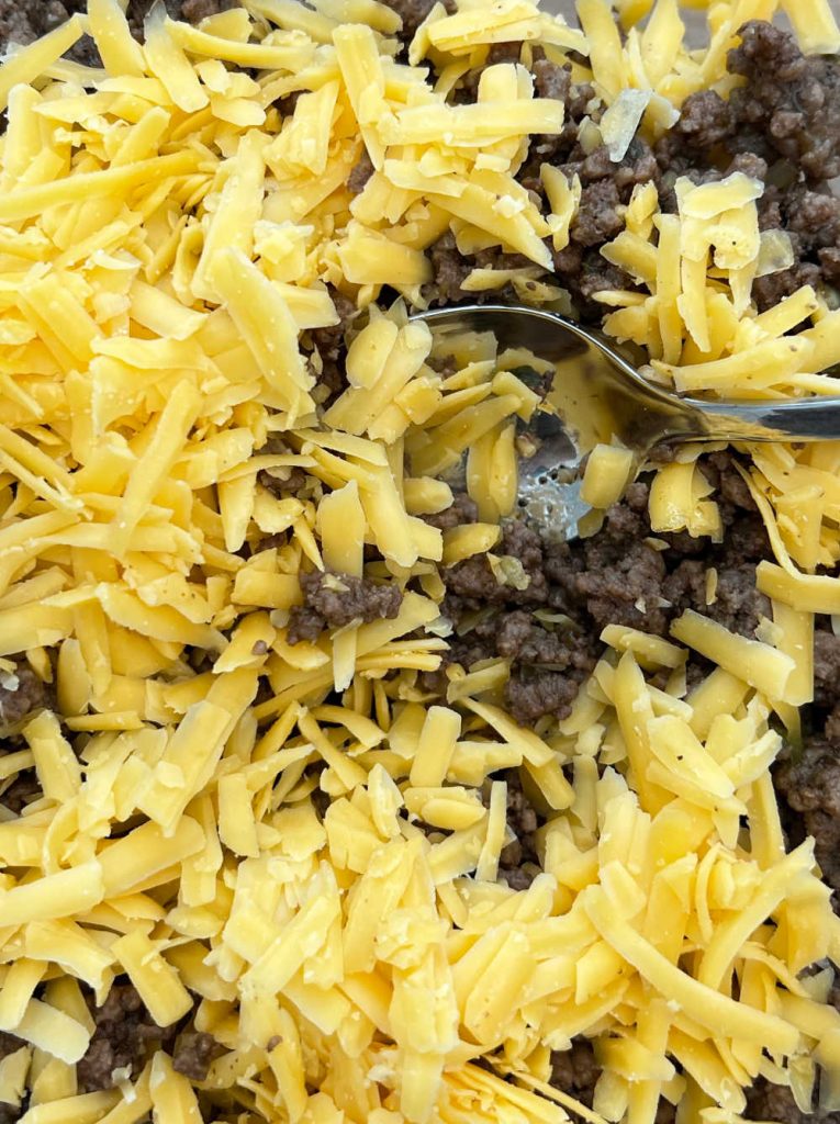 cook seasoned ground beef with shredded cheese.