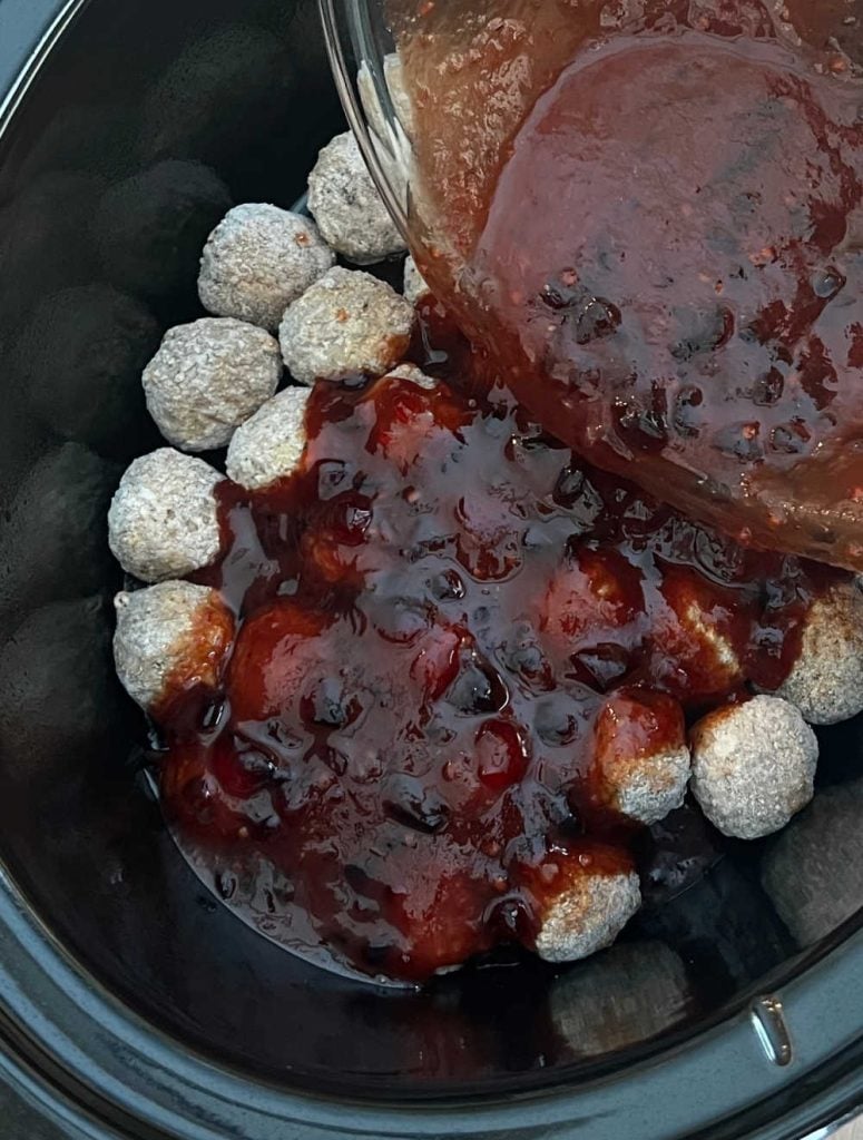 pour sauce over frozen meatballs in slow cooker.