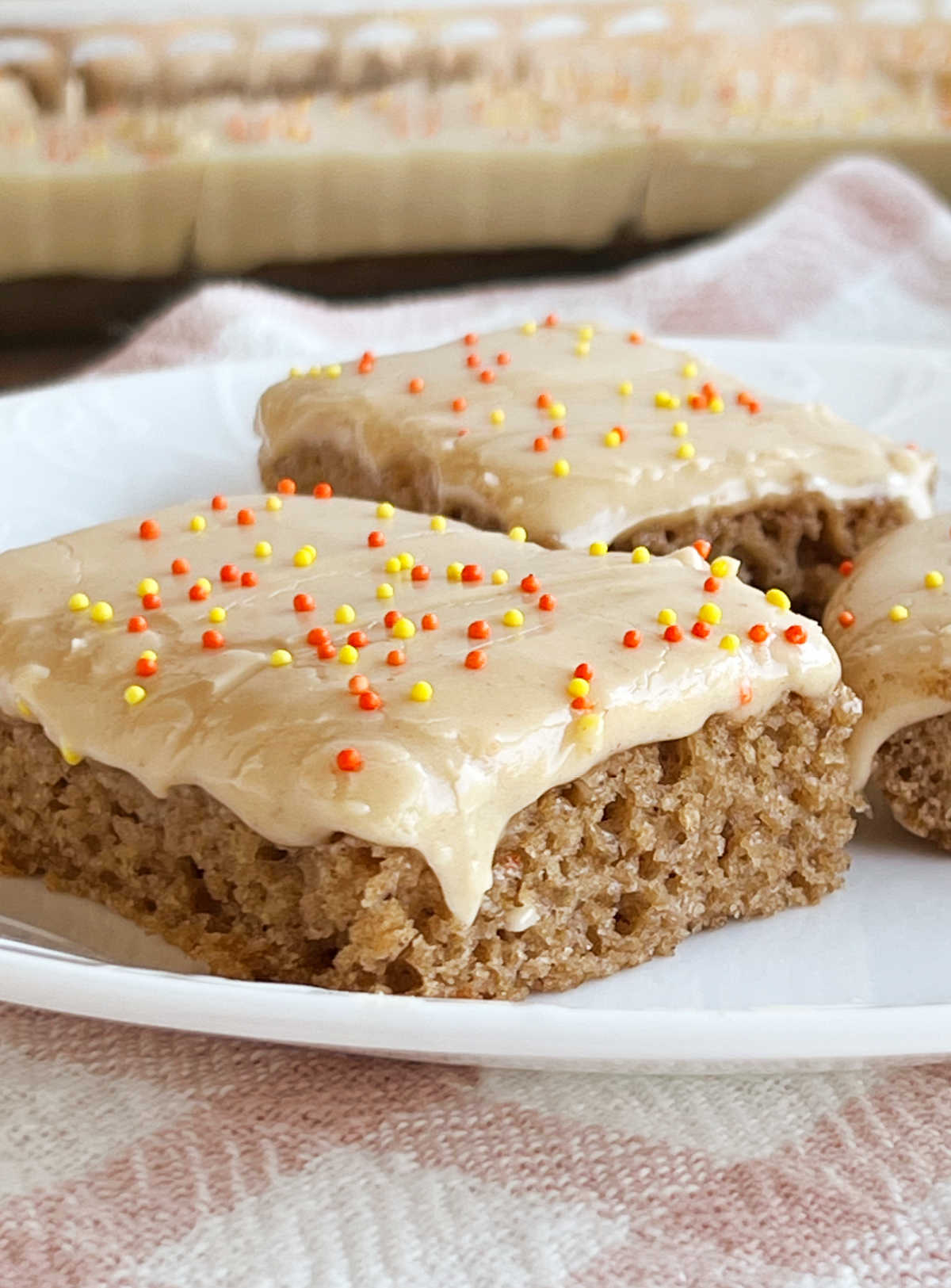 applesauce bars with cream cheese frosting on plate.