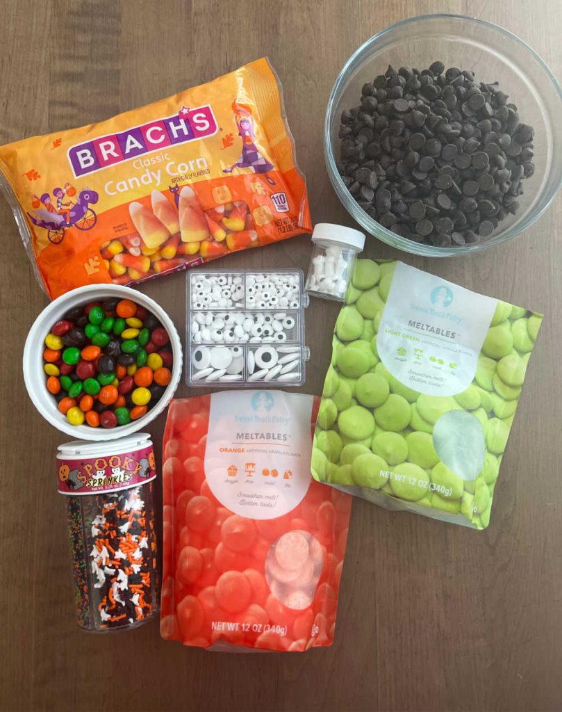 candy melts, candy corn, chocolate chips, candy eyeballs and candies.