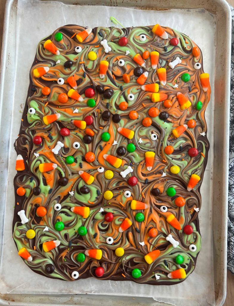 Halloween candy bark on a sheet pan.